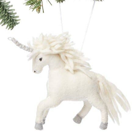 White unicorn ornament hanging on a Christmas tree