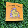 Card with illustration of a person and text 'Fat and Happy (and none of your business)' on grass.