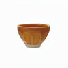 small stoneware bowl with golden yellow glaze