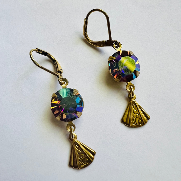 Pair of gold earrings with colorful gemstones on a white background