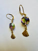 Gold earrings with colorful gemstones on a white background