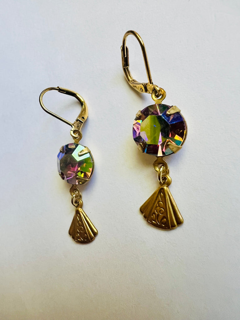 Gold earrings with colorful gemstones on a white background