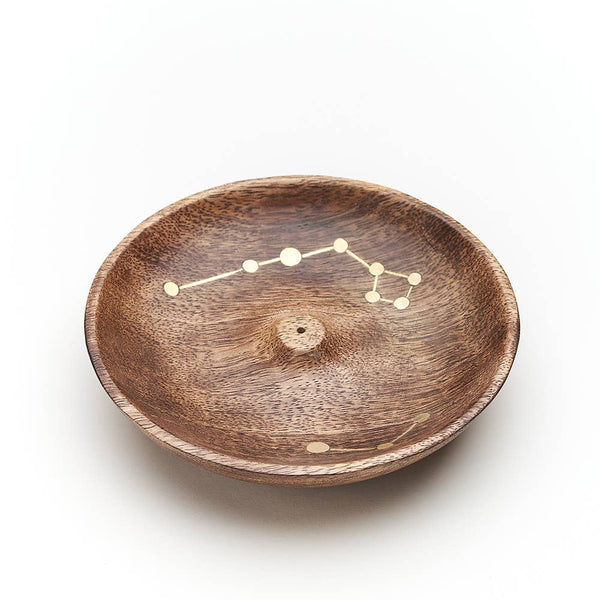 Wooden bowl with star constellation design on a white background