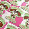 Stickers with cartoon dog design and text on a pink background